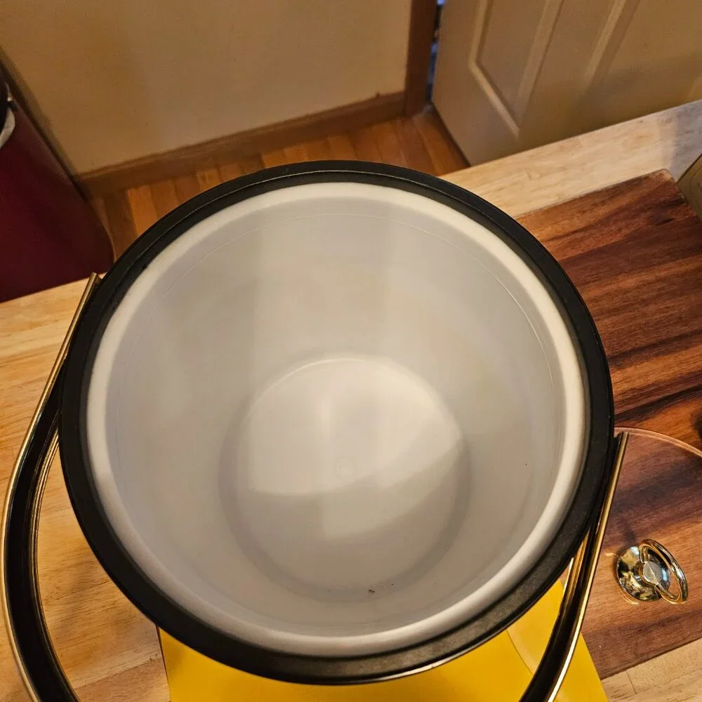 vintage ice bucket black with a sailboat design with a gold touch